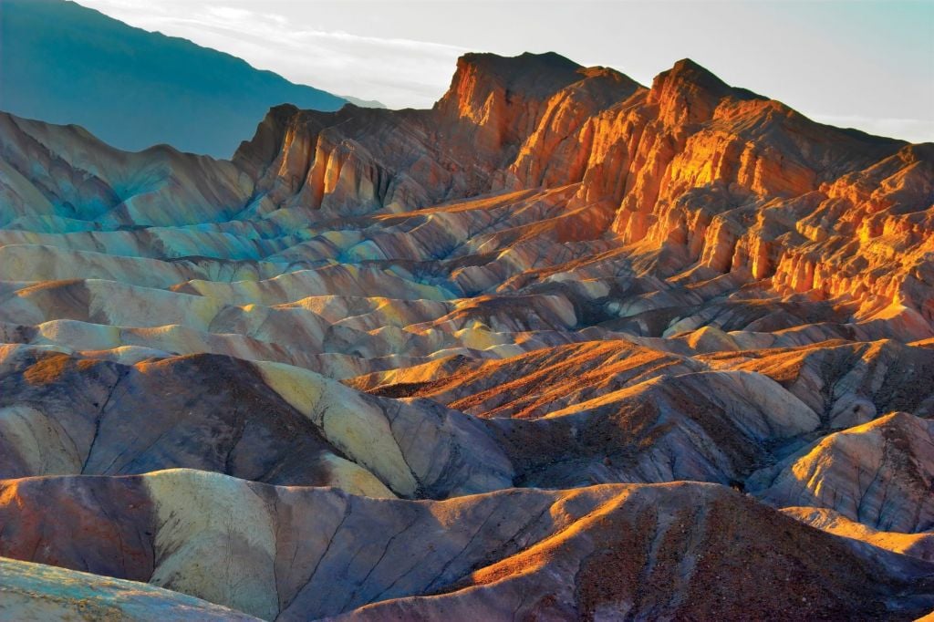 The sun dappled Zabriskie Point at Death Valley National Park.