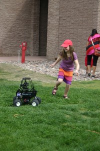 A child plays with the Mars Mini-Rover at the expo at the Furnace Creek Visitor Center. The Park is hosting both a daytime and nighttime expos with booths, demonstrations, and night sky viewing. NPS Photo.