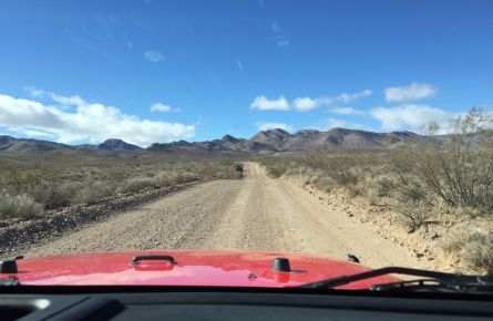 A jeep drives towards Titus Canyon in Death Valley National Park.