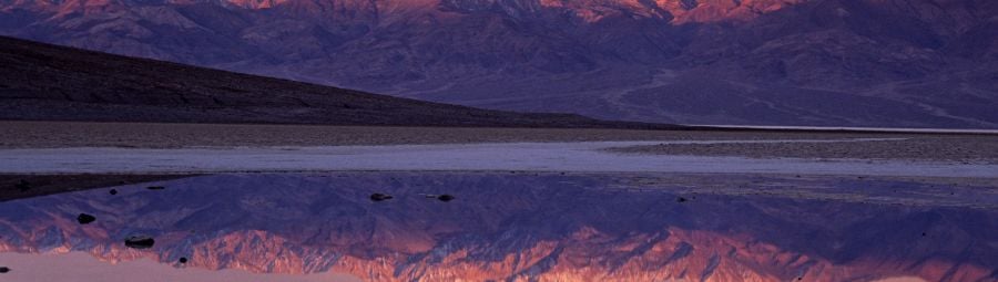 Sunrise colours on Telescope peak reflected in pond at Badwater